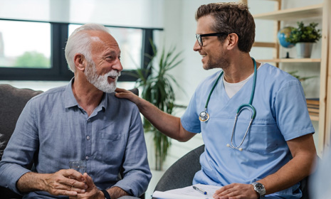 Medical provider consulting seated patient