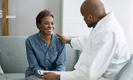 Clinician speaking with patient on couch